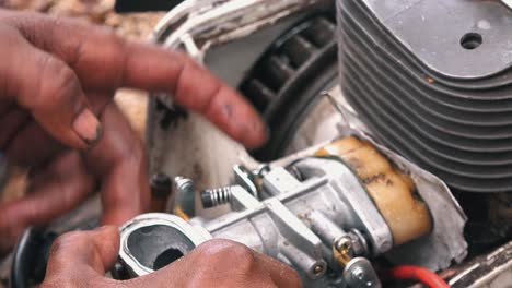 Close-Shot-of-Hands-Working-on-a-Chainsaw-Engine