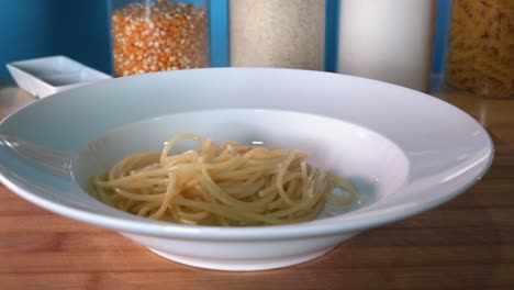 Adding-Freshly-Boiled-Pasta-to-a-Pasta-Bowl