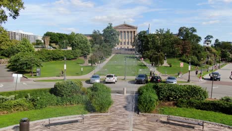 Aerial-rising-dolly-forward-above-water-fountain-and-sculpture-tracking-toward-Philadelphia-Museum-of-Art