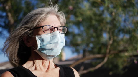 A-woman-hospital-patient-wearing-a-medical-mask-outdoors-to-prevent-the-spread-of-contagious-illness-during-an-outbreak-or-epidemic