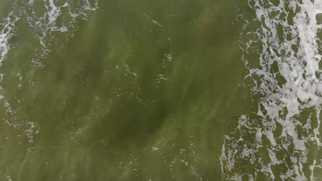 Zenithal-drone-image-waves-in-green-sea