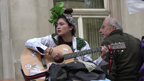 A-protester-plays-music-at-the-Extinction-Rebellion-protests-in-London,-UK