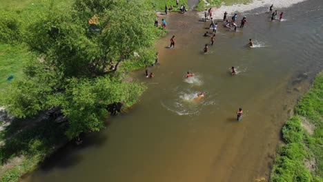 Aerial-shot-of-people-swimming-in-muddy-river-in-Bulgaria