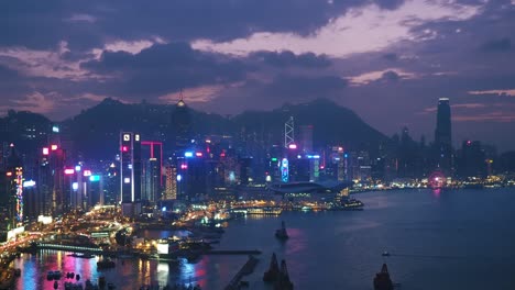 Elevated-view-overlooking-Victoria-Harbour-skyline-at-dusk,-Hong-Kong-Island,-HK