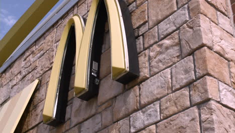 Stabilized-shot-of-McDonald's-double-arches-logo-on-the-side-of-a-restaurant-building