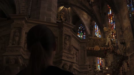 Over-The-Shoulder-Shot-of-Female-Tourist-Appreciating-Ceiling-Architecture-in-Cathedral
