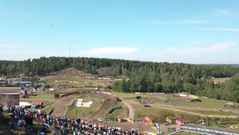Airplane-show-over-motocross-circuit,-MXGP-of-Sweden,-Panning-shot