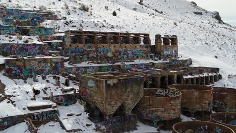 A-drone-orbits-the-rusty-Old-Tintic-Mill-in-Geneloa,-Utah,-revealing-the-decaying-water-tanks,-leaching-tanks,-roasters-and-crusher-built-in-1920