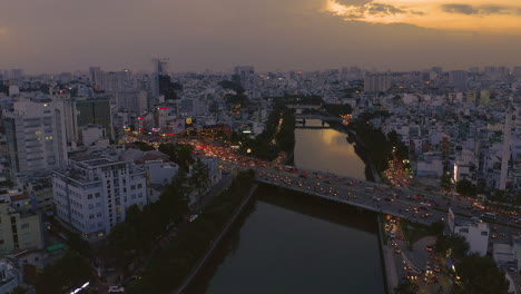 Evening-sunset-drone-footage-looking-pushing-in-on-Dien-Bien-Phu-Bridge-the-Hoang-Sa-canal-area-of-Binh-Thanh-district,-Saigon-or-Ho-Chi-Minh-City,-Vietnam