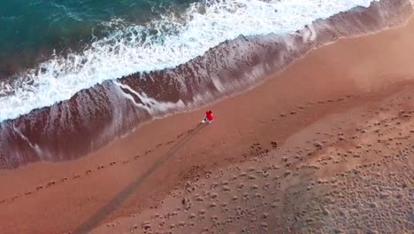 Sunny-beach-sand-footsteps--waves