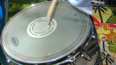 Evans-drum-head,-percussion-instrument,-snare-drum,-drum-rolling-and-sticks,-rhythm,-playing-instrument-outside-in-park-during-summer,-music-show,-Canada's-day