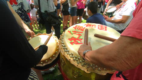 Close-up-view-of-percussion,-music-instruments,-people-playing-drums,-tam-tam,-drum-roll,-people-watching,-outside-in-park,-Montreal,-Canada's-day