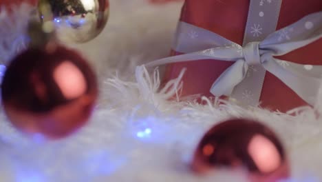 Gift-at-Christmas-with-baubles-and-flashing-Christmas-lights