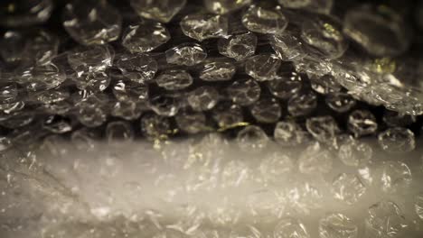 slowly-pulling-out-of-the-bottom-of-a-bubble-wrap-bag-at-first-and-then-speeding-towards-the-opening