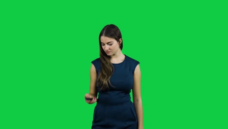 Girl-usees-a-TV-remote-in-front-of-a-green-screen