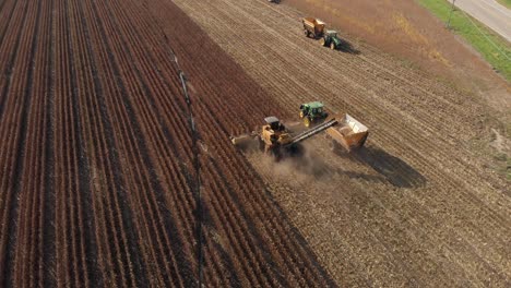 aerial-view-rotating-counter-clockwise-from-behind-a-harvester-picking-seed-corn-for-next-years-planting