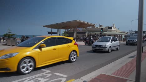 cars-and-motorcycles-going-by-on-henley-beach-square