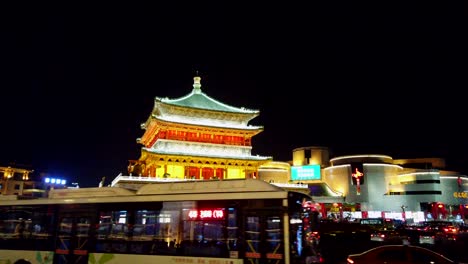 Xian,-China---July-2019-:-Hectic-traffic-in-front-of-the-beautifully-lit-and-illuminated-Xian-bell-drum-tower-at-night,-Shaaxi-province,-central-China