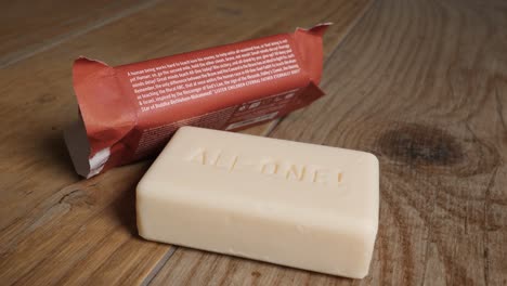 Vegan-natural-soap-bar-and-wrapping-paper-on-wooden-table