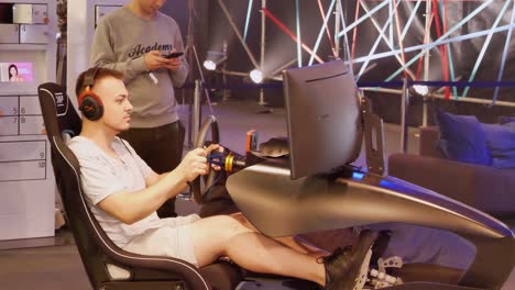 this-simulator-has-to-feel-like-a-real-car,-the-male-player-is-full-in-the-car-race-he-plays