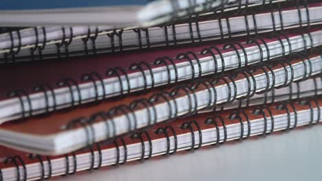 Close-Shot-of-an-Assortment-of-Ring-Bound-Books-Rotating