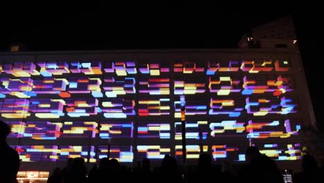 Colorful-light-show-on-building’s-exterior-wall-at-nighttime-event-in-Eindhoven,-Netherlands