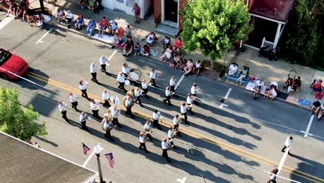 Aerial-turn-and-pan-down-as-marching-band-plays-during-Fourth-of-July-parade-celebration