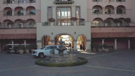 Aerial,-drone-shot,-passing-the-gate,-toward-the-fountain,-at-of-the-Sheraton-hotel,-in-Cabo-San-Lucas,-in-Baja-Peninsula,-Mexico