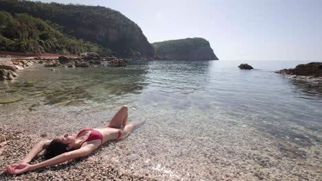 Skinny-lady-in-her-red-bikinis-on-the-coast-of-Montenegro-on-sunny-summers-days
