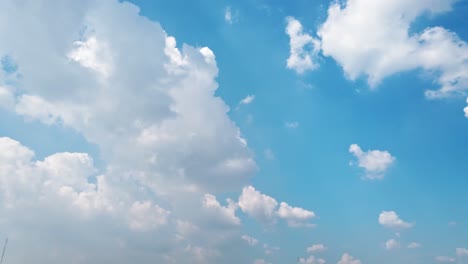 White-puffy-clouds-and-blue-sky-time-lapse-with-long-second-duration-for-background-and-graphics-in-daylight