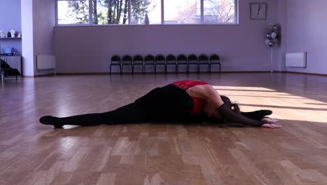 Female-dancer-stretching-before-dancing