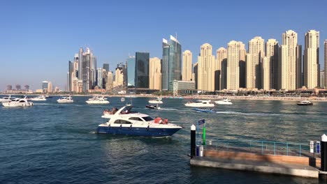 Wide-angle-of-Dubai-Marina-cityscape-with-boats-and-cruising-yachts-on-the-sea-during-daytime