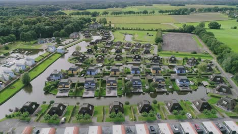 Aerial-Flyover-a-Small-Dutch-Holiday-Park-during-Summer-with-Different-Houses-surrounded-by-Water