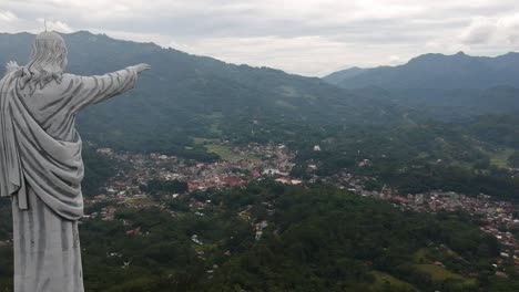 Aerial-over-Big-and-Giant-Jesus-Statue-Standing-above-the-city-of-Toraja-Makale