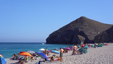 People-enjoyng-windy-Playa-de-los-Muertos-beach-in-Spain