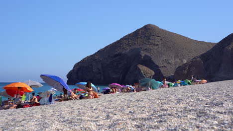 People-walk-on-windy-Playa-de-los-Muertos-beach-in-Almeria
