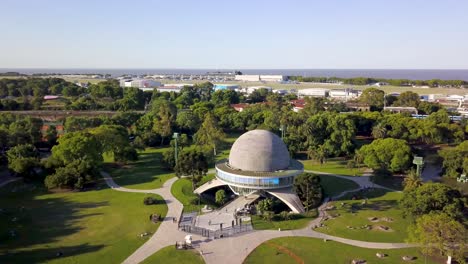 Aerial-dolly-out-of-Galileo-Galilei-Planetarium-revealing-La-Plata-river-on-background