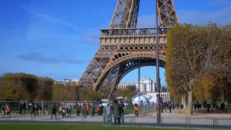 Nov-2019,-Paris,-France:-tourists-in-front-of-the-Tour-Eiffel-in-a-sunny-autumn-day
