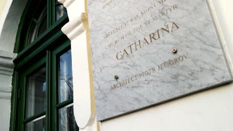Slow-pan-of-St-Martyr-Catherine-Church-signage-at-front-facade