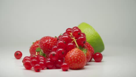 Strawberries,-Lime-And-Red-Currant---Set-Of-Fruits-In-A-Turntable-With-White-Background---Close-Up-Shot