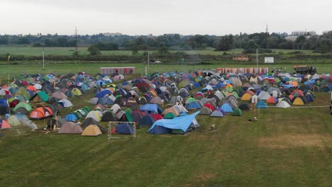Aerial-View-of-Multi-Colored-Tents-Pitched-in-a-Field-at-a-Music-Festival
