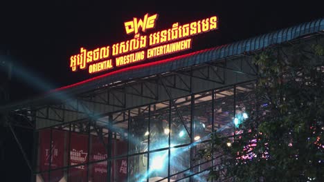 Medium-Exterior-Static-Shot-of-the-New-Bright-Wrestling-Center-Sign-With-Lights-in-Siem-Reap-In-the-Night