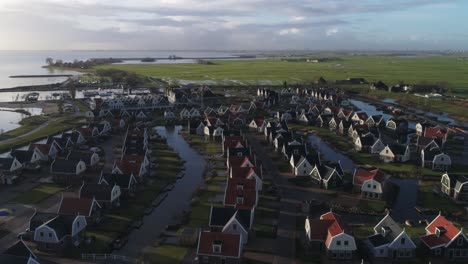 Wide-Aerial-of-a-Small-Dutch-Holiday-Park-during-Sunset-with-Long-Shadows-and-Countryside-in-Background