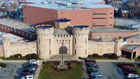 Lancaster-County-Prison-with-historic-towers-above-main-entrance,-aerial-dolly-shot