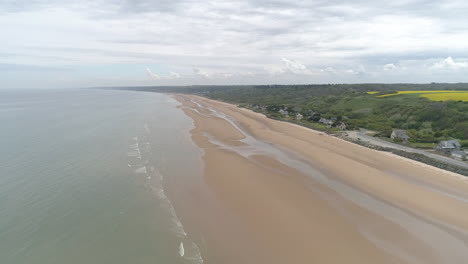 Establishing-aerial-drone-view-of-isolated-Omaha-Beach-near-Colleville-sur-Mer,-Normandy,-France