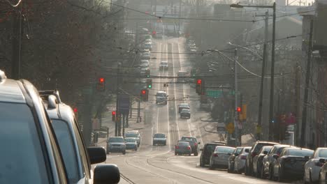 Woodland-Avenue,-West-Philadelphia,-cars-and-trolleys-at-traffic-lights