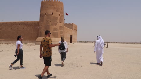 Vloggers-on-a-guided-tour-through-Al-Zubara-Fort-in-Qatar