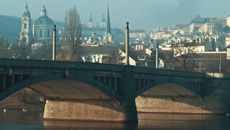 Misty-morning-by-the-Vltava-river-and-Prague-Castle-with-foggy-weather-empty-bridge-calm-quiet