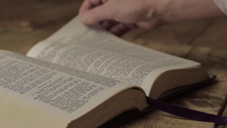 Hand-turning-psalms-Bible-pages