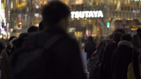 Group-of-pedestrians-waiting-to-cross-Shibuya-scramble-at-night-in-Tokyo,Japan